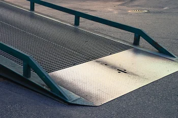 Heavy-duty industrial steel yard ramp with safety rails for warehouse loading and unloading
